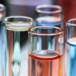 Test tubes filled with colorful liquids in shades of blue, red, and green.